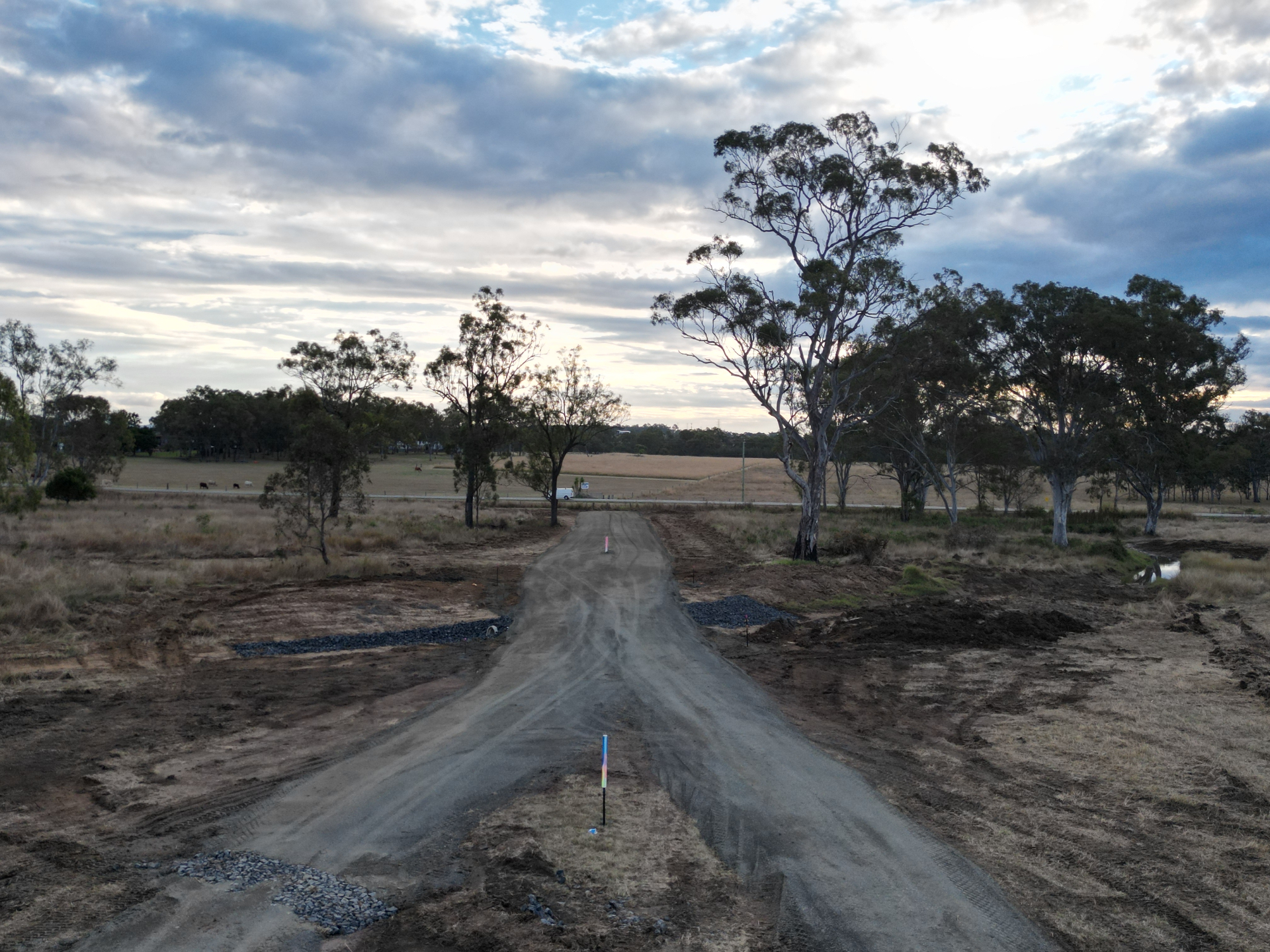 Aerial view of a freshly formed gravel access road with blue-metal rock pitching at dusk on a Darling Downs lifestyle block
