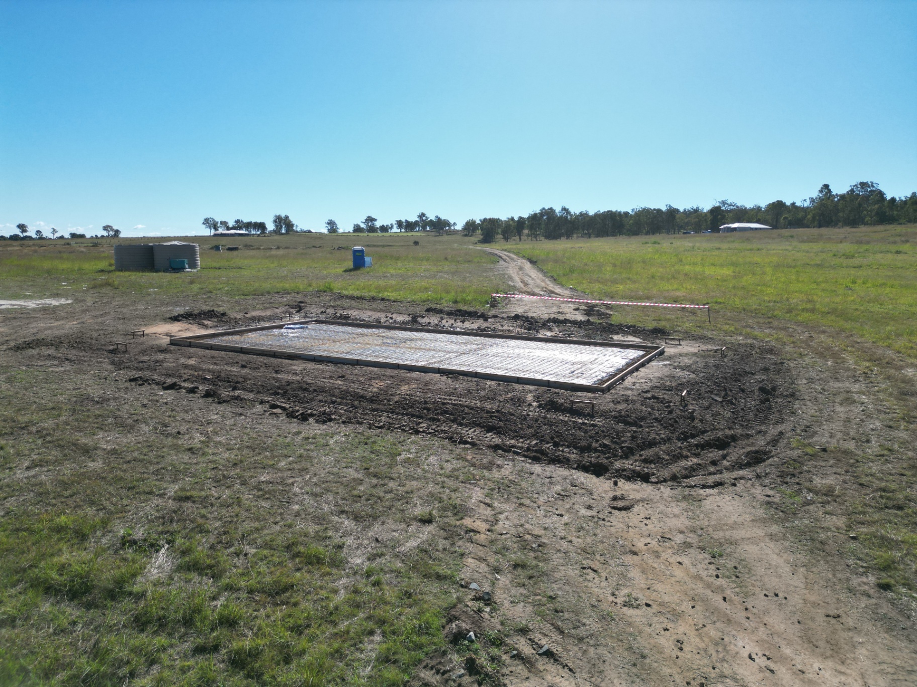 Prepared concrete slab with steel mesh and formwork on a rural property