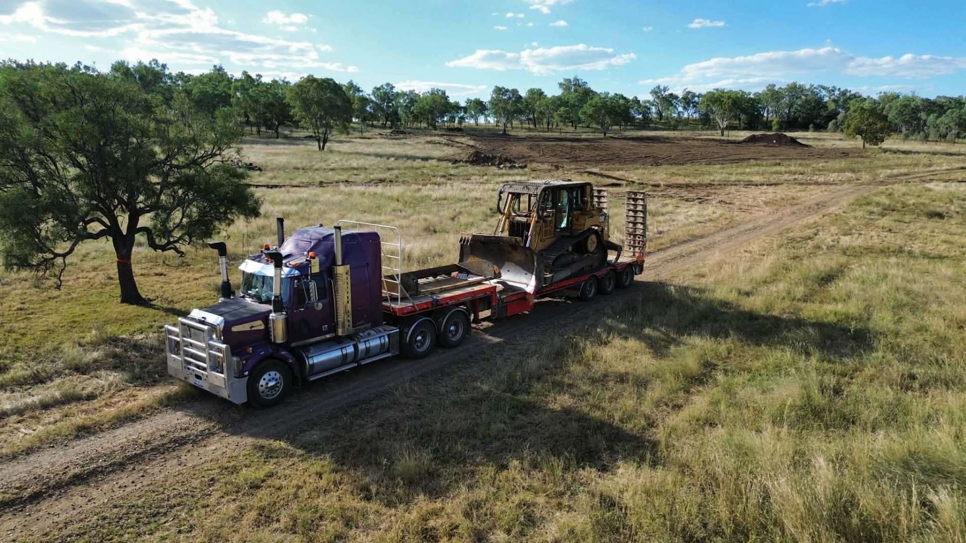 Western Star prime mover with float carting a CAT bulldozer to a Darling Downs job