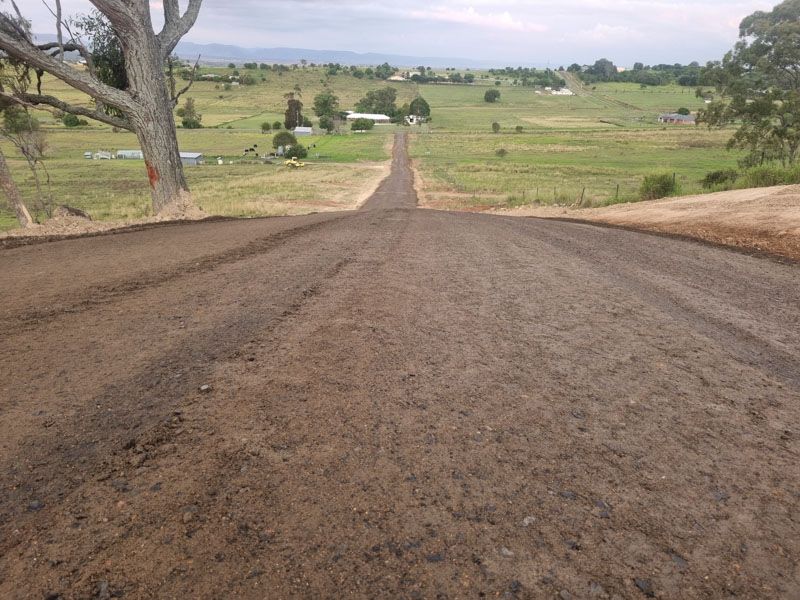 Long rural road graded through Darling Downs farmland